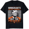Immigrants Are Not Criminals But The President Is Shirt in Black, featuring the stark white graphic print.