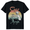 A person wearing a black Grr Argh Zombie Vintage 90s Horror Shirt with a distressed retro graphic.