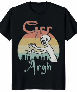 A person wearing a black Grr Argh Zombie Vintage 90s Horror Shirt with a distressed retro graphic.