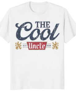 A man smiling while wearing The Cool Uncle Pregnancy Announcement Shirt for a surprise family reveal.