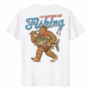A vintage-style Bigfoot Sasquatch I'd Rather Be Fishing Shirt in a forest setting.