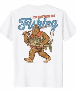 A vintage-style Bigfoot Sasquatch I'd Rather Be Fishing Shirt in a forest setting.