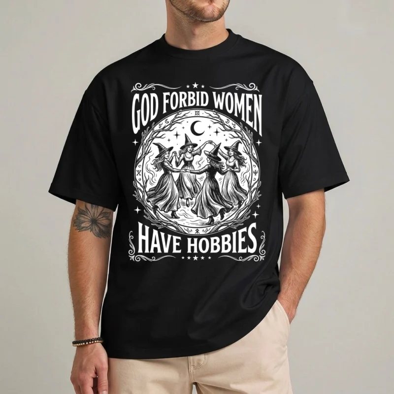 God Forbid Women Have Hobbies Shirt | Witch Halloween Tee 2 God Forbid Women Have Hobbies Shirt in black with four witches dancing under a crescent moon