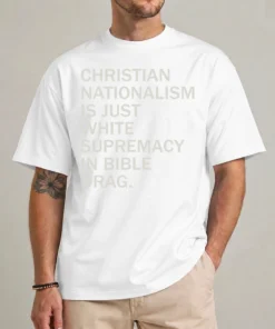 Model wearing a white anti Christian nationalism shirt with pale stacked Christian Nationalism Is Just White Supremacy In Bible Drag lettering