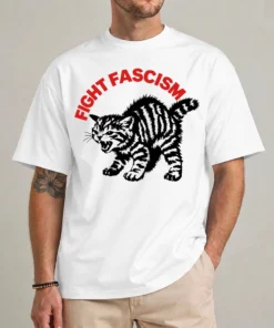 Model wearing a white Fight Fascism cat shirt with curved red lettering and an angry black striped cat