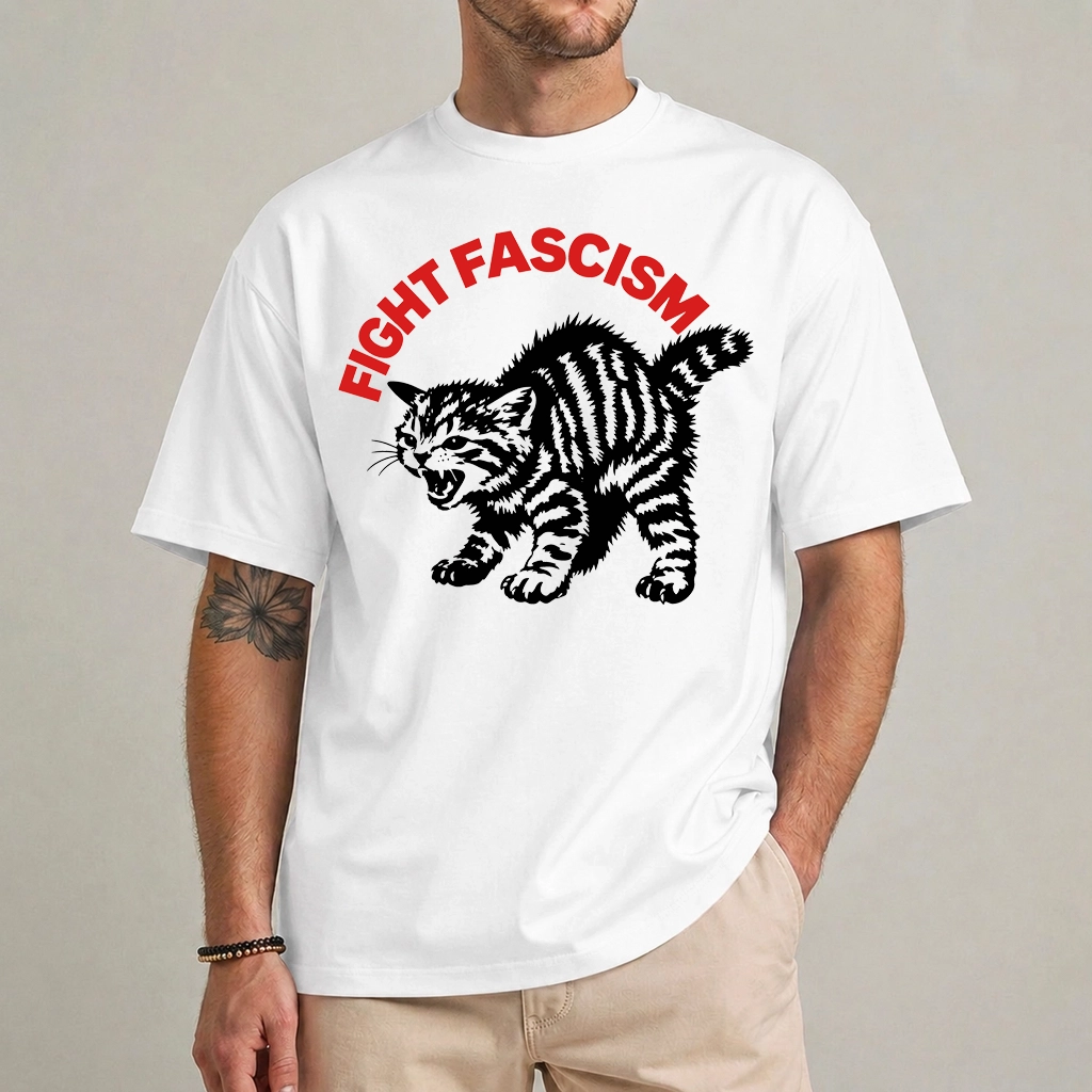 Fight Fascism Cat Shirt | Angry Striped Cat Graphic 1 Model wearing a white Fight Fascism cat shirt with curved red lettering and an angry black striped cat