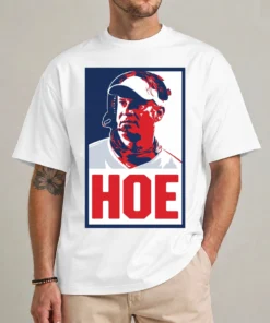 Model wearing a white Lane Kiffin Hoe shirt with a red-and-blue portrait and large red HOE caption