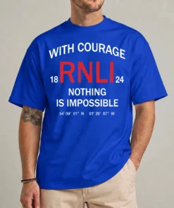 Model wearing a blue RNLI courage shirt with red RNLI initials and white With Courage Nothing Is Impossible lettering