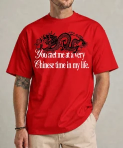Person wearing a red Very Chinese Time Shirt with a black dragon and white meme slogan