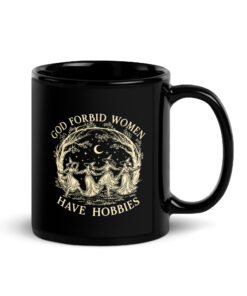 God Forbid Women Have Hobbies mug, black glossy mug with four witches dancing in a ring under a crescent moon in cream ink