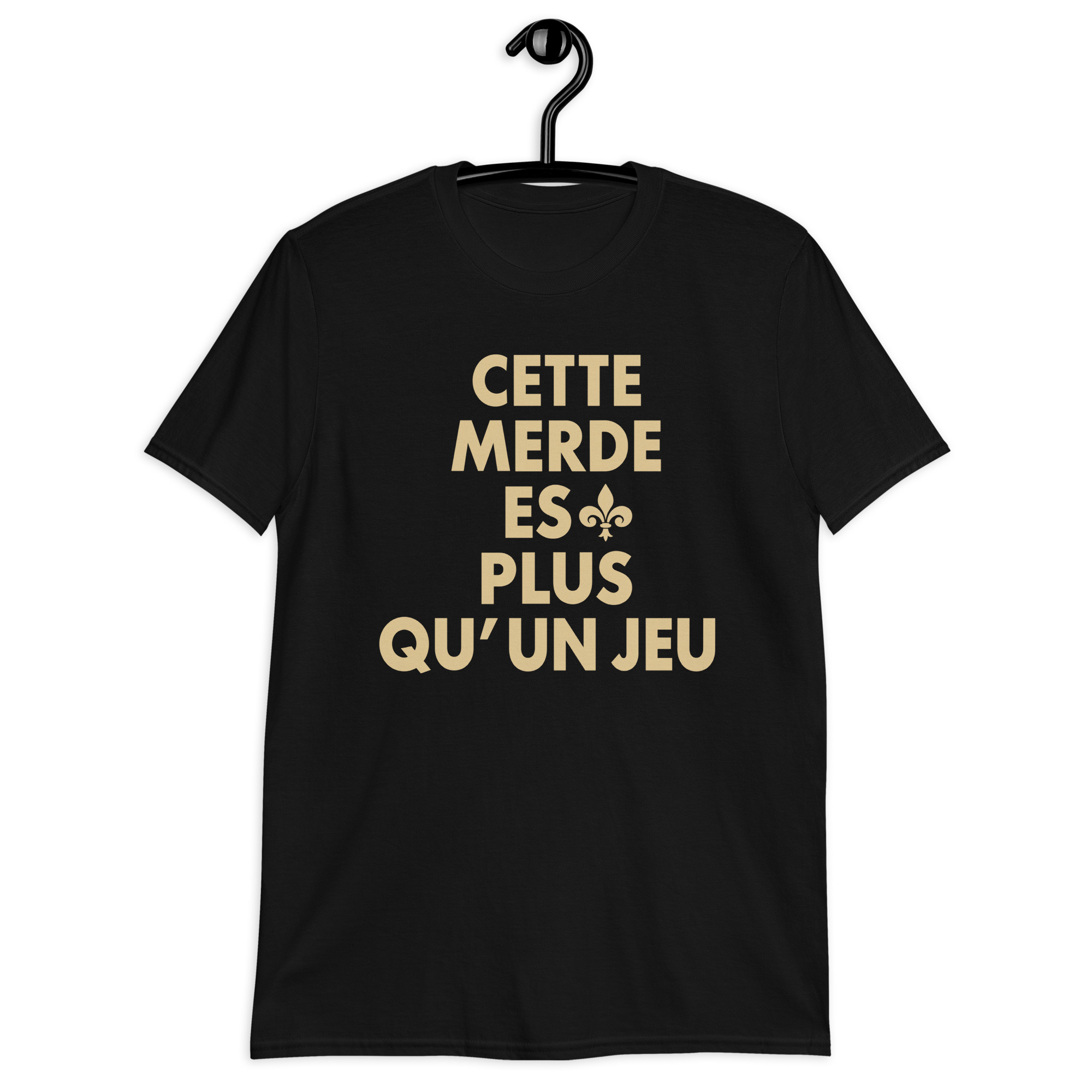 Cette Merde Est Plus Qu’un Jeu Saints Shirt 1 Cette Merde Est Plus Qu’un Jeu — black shirt with stacked gold French slogan lettering and a fleur-de-lis beside ES, front view