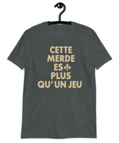 Cette Merde Est Plus Qu’un Jeu Saints Shirt 7 Dark heather shirt with stacked gold French slogan lettering and a fleur-de-lis beside ES, front view