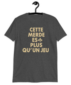 Cette Merde Est Plus Qu’un Jeu Saints Shirt 9 Dark heather grey shirt with stacked gold French slogan lettering and a fleur-de-lis beside ES, front view